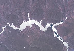 Der Stausee von der ISS aus gesehen. Die Staumauer ist links; Norden ist unten