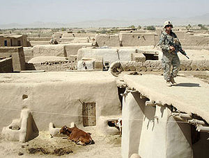 Ein Soldat sucht in Alizai nach Waffenverstecken