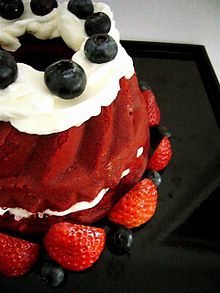 Red velvet cake with whipped cream blueberries and strawberries.jpg
