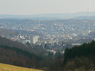 Blick auf Geisweid (untere Bildhälfte) und Weidenau mit dem Giersberg (obere Bildhälfte) und der dortigen Senderanlage (rechter Bildrand)