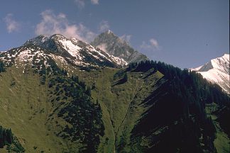 Wannenkopf (der bewaldete Berg im rechten Bildbereich) von Nordwesten, vom Älpelekopf. In Bildmitte die Höfats, am rechten Bildrand das Rauheck.